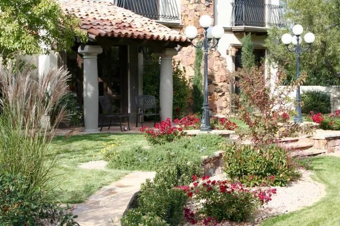 A house with a red tile roof and a walkway in front of it