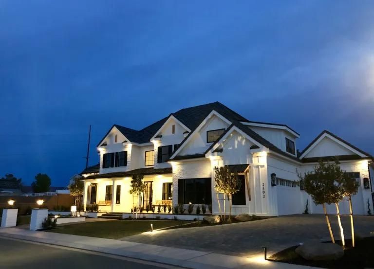 A large white house is lit up at night