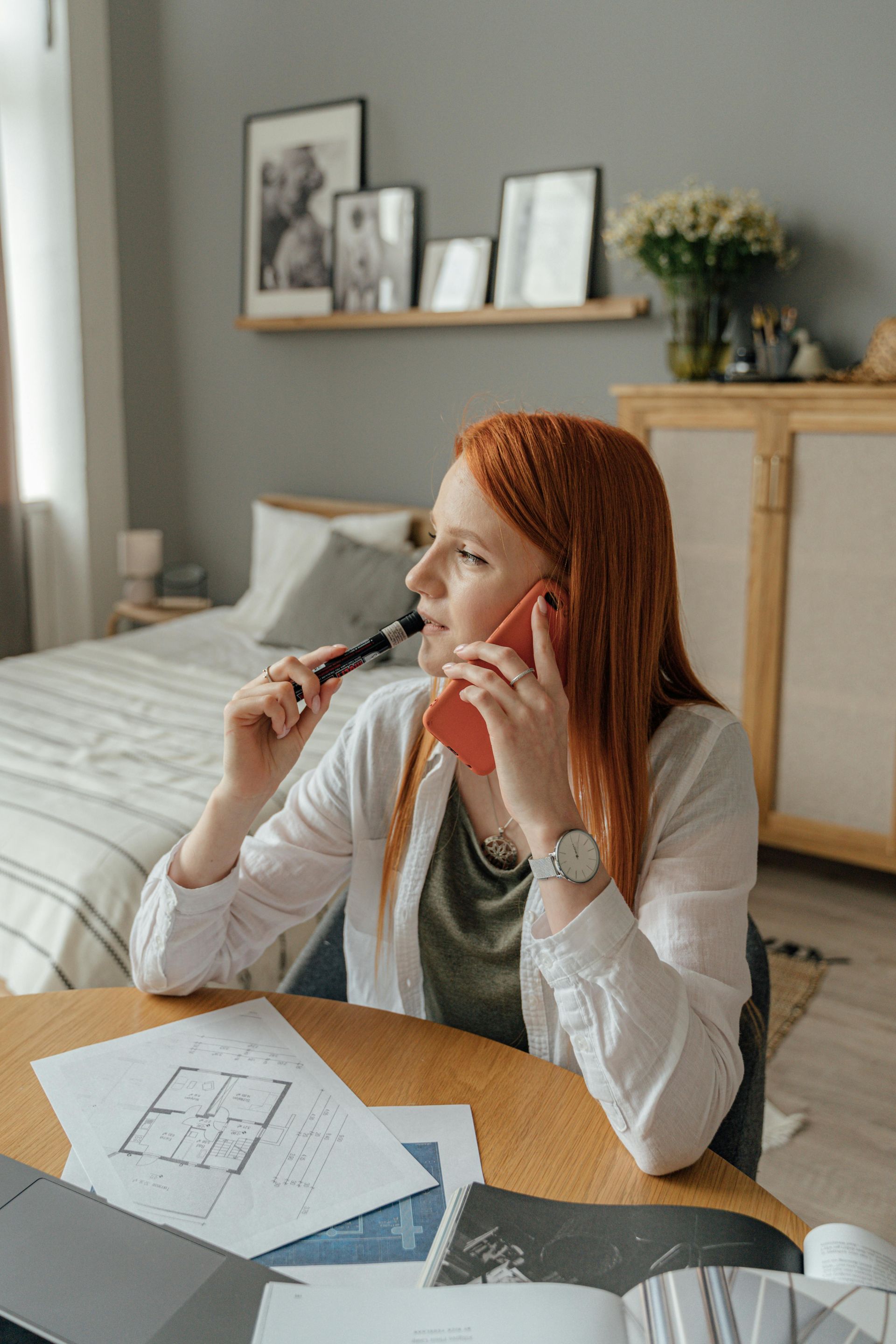 Woman with red hair calling about a pressure washing quote 