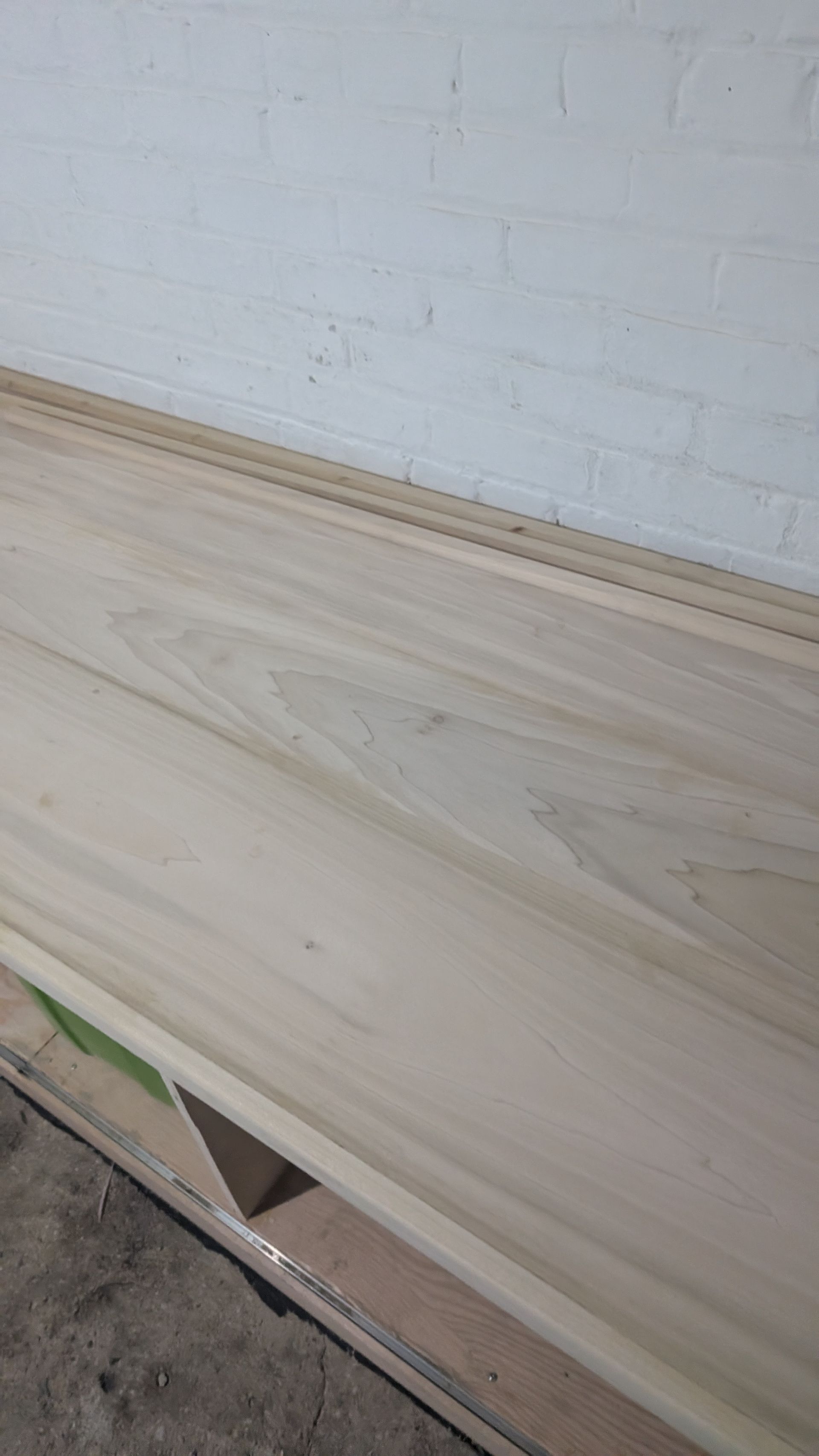 Light wood surface with a white wall in the background.