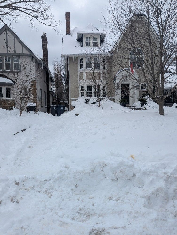 Snow-covered houses with icicles hanging from the roof. Winter scene.