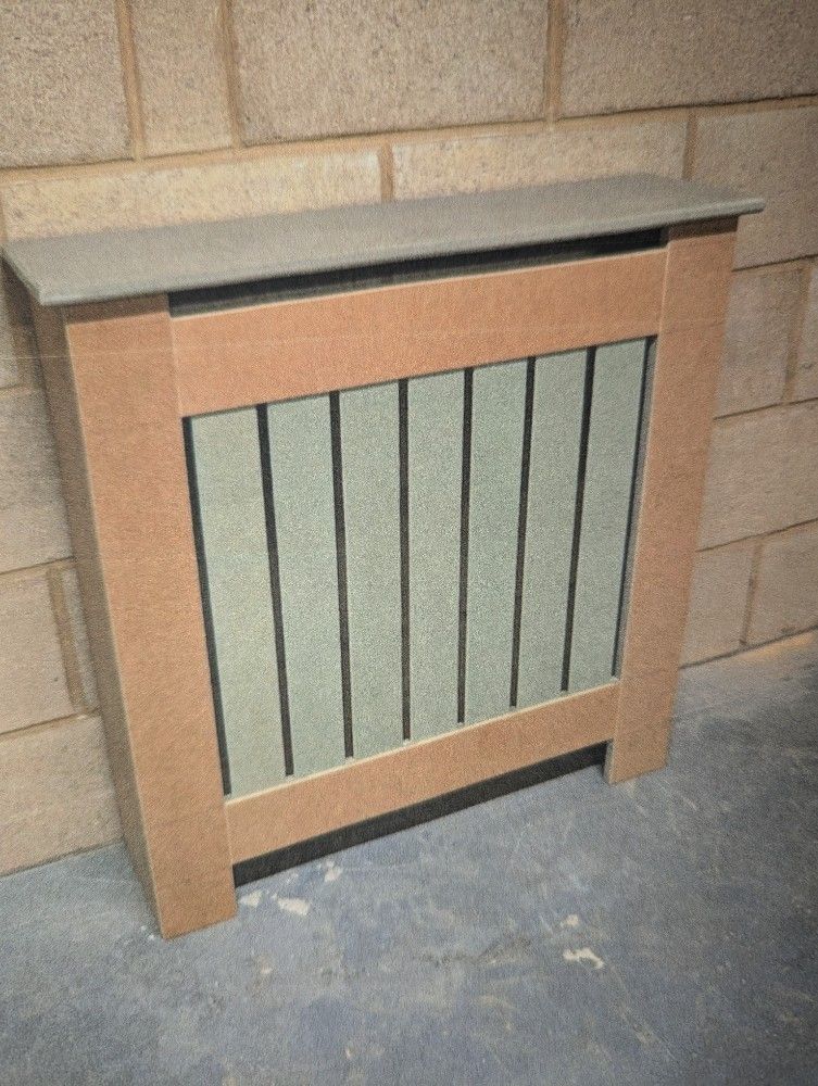 Wooden radiator cover with a grey top and vertical black bars against a stone wall.