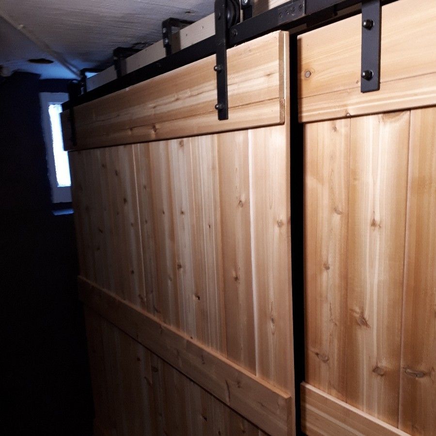 Wooden barn doors on a black track. Light brown wood, dark hardware.