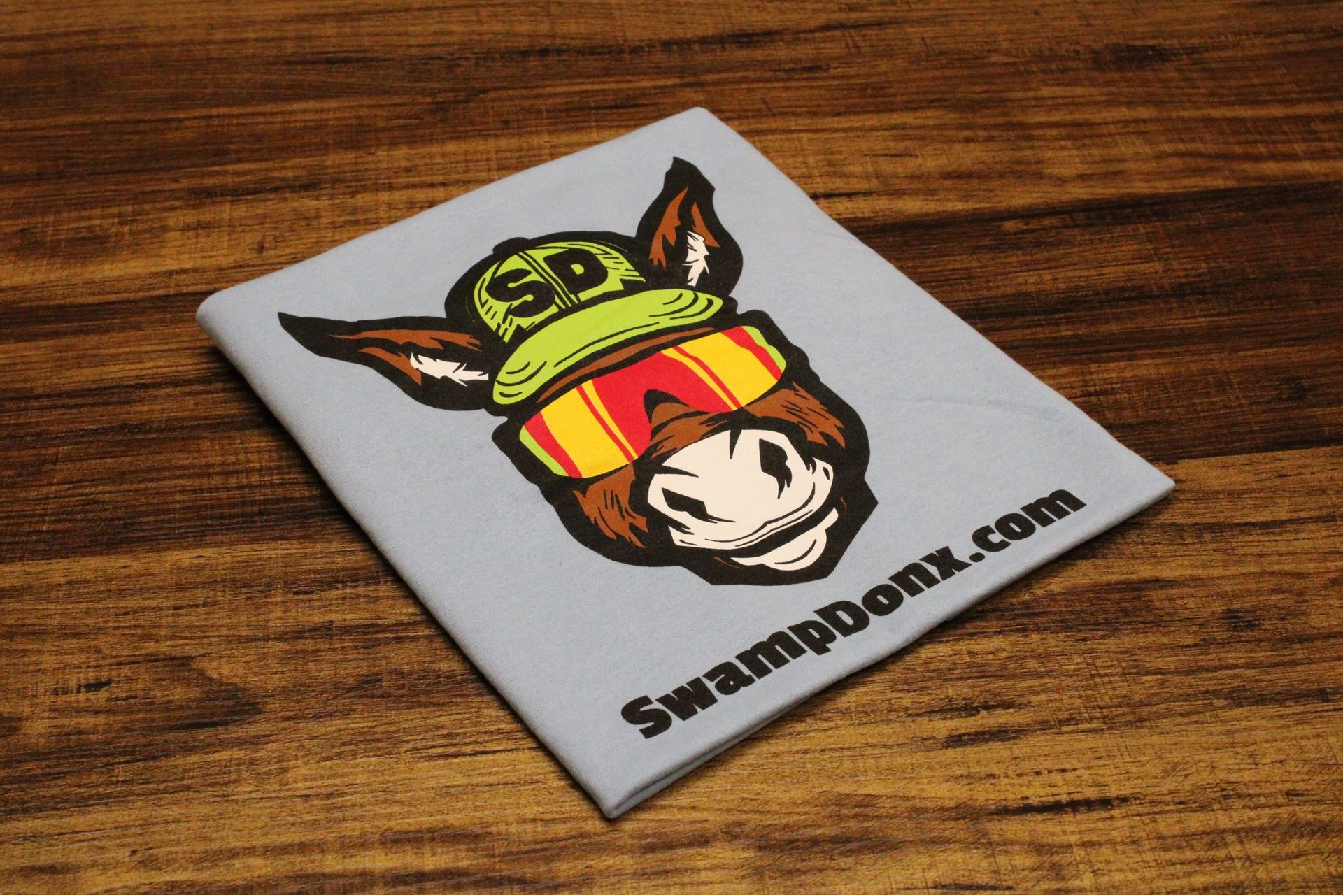 Four shirts with donkeys on them are stacked on top of each other