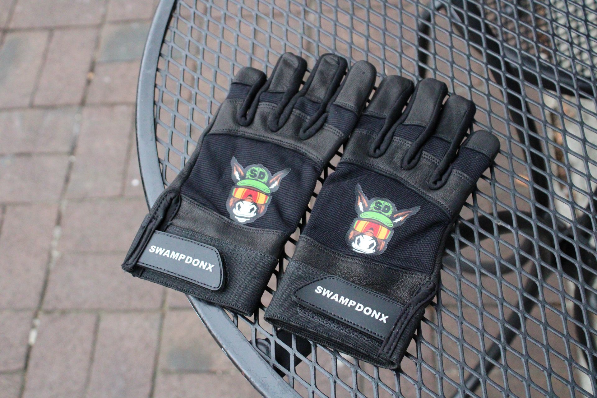 A pair of black gloves with a donkey on them