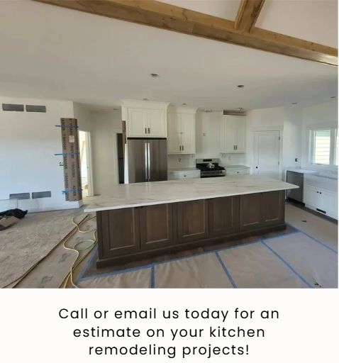 A kitchen remodeling project showing a white-cabinet perimeter, a large dark wood island with stone countertop, and beams.