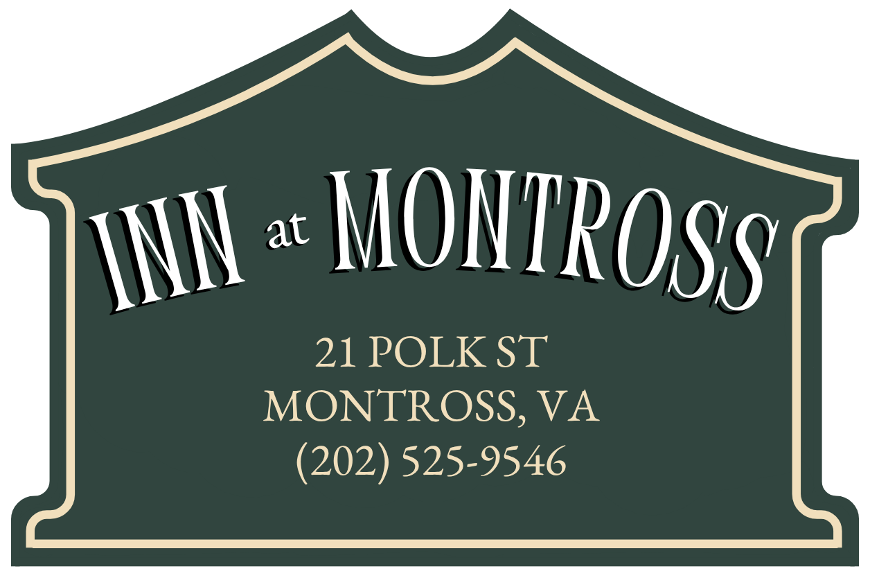 Sign for Inn at Montross in Montross, VA; features address and phone number, dark green with white text.