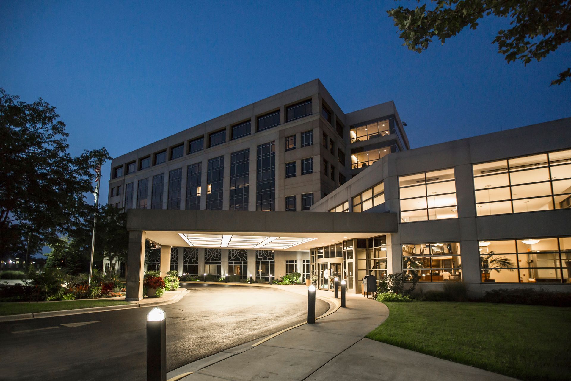 A large building with a lot of windows is lit up at night