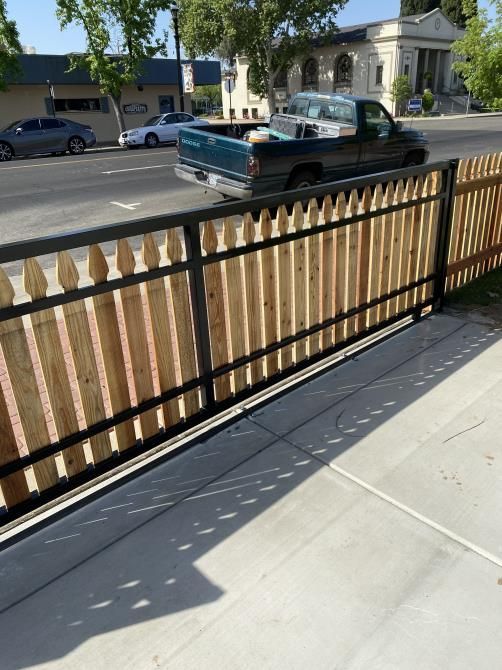 A truck is parked behind a wooden fence