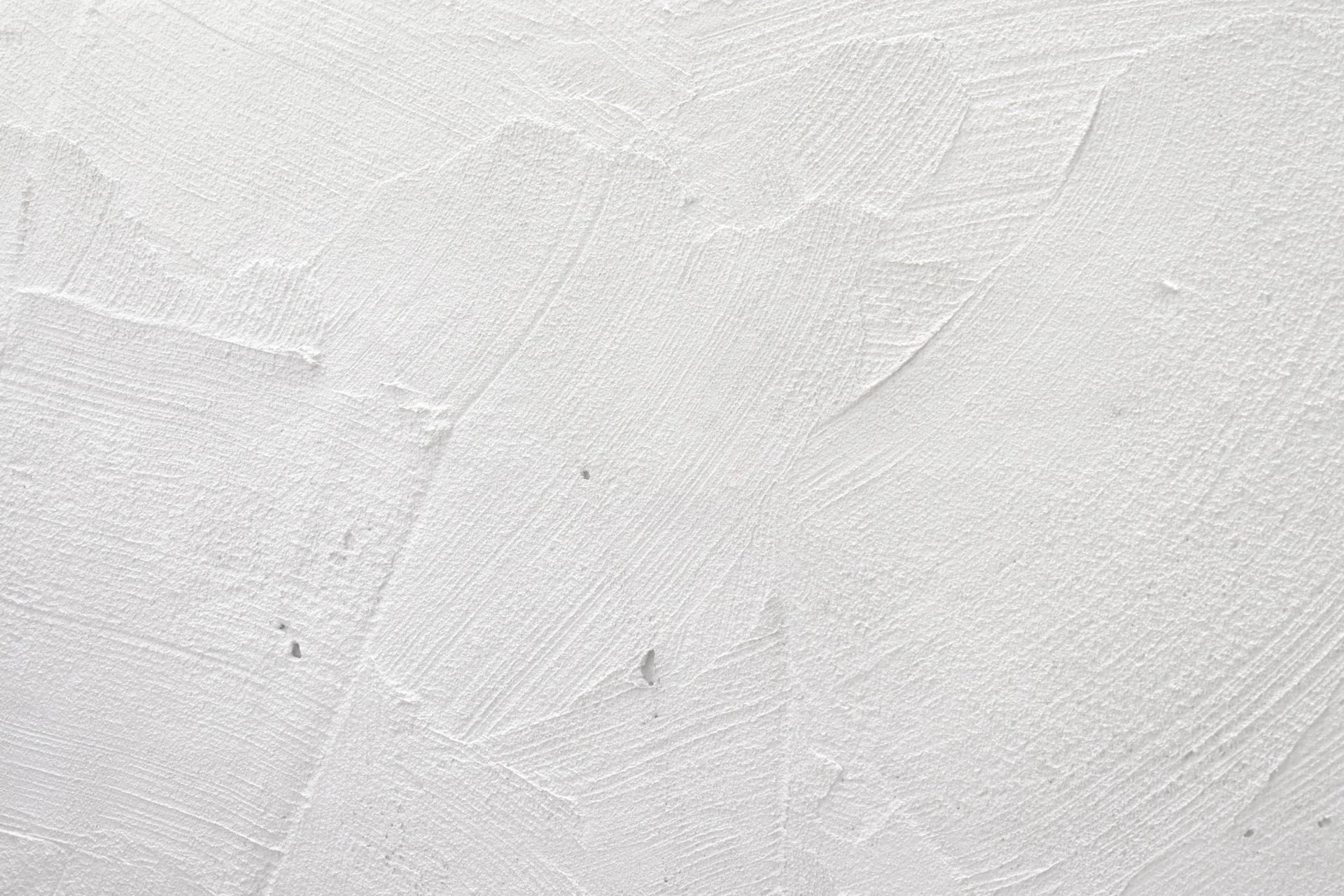 A close up of a white wall with a texture.