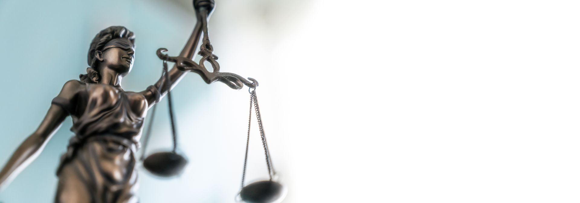 Statue of lady justice on bright background - Side view with copy space Statue of lady justice on bright background - Side view with copy space