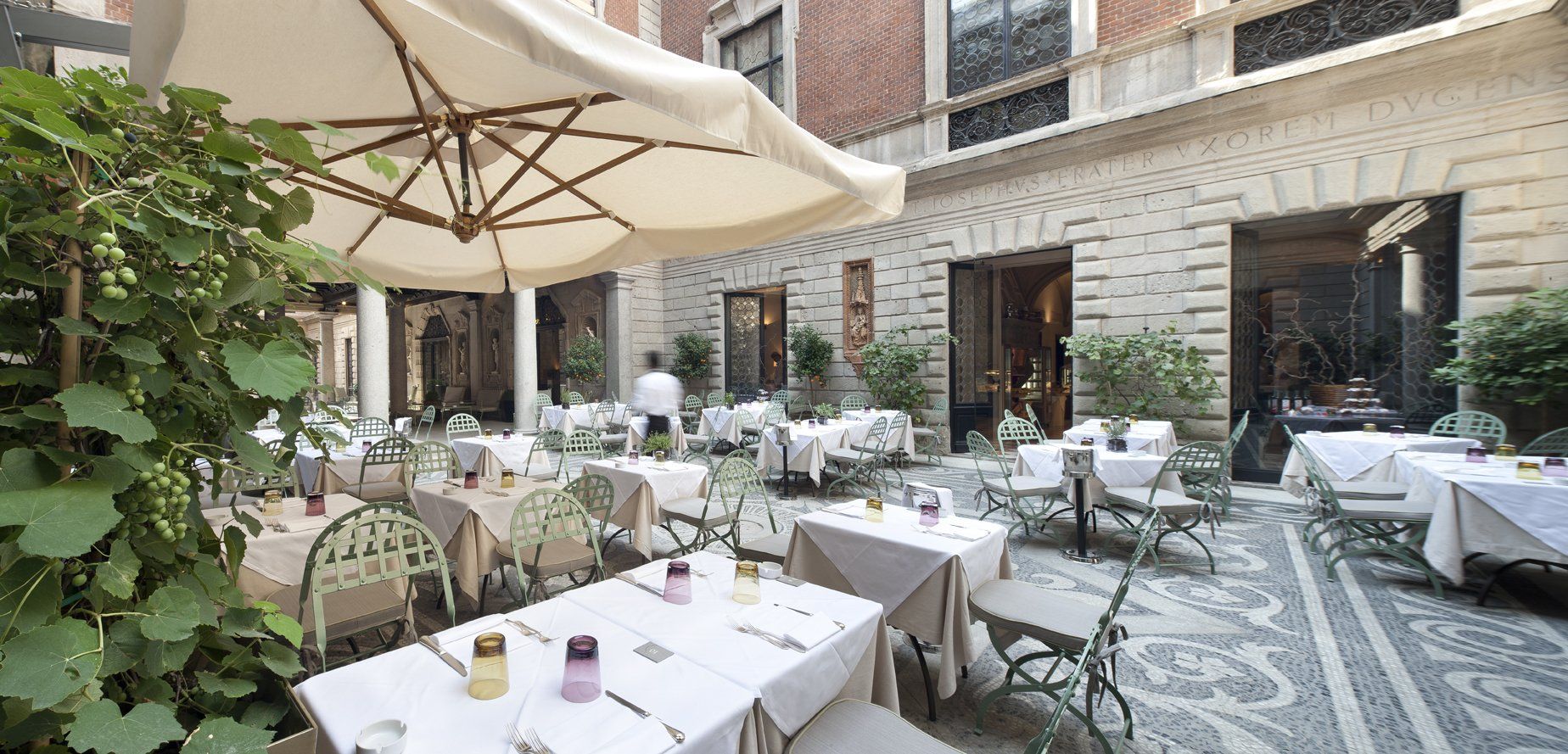 Un ristorante con tavoli e sedie sotto l'ombrellone