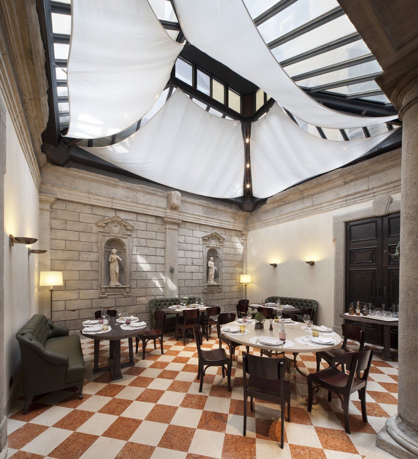 Una sala da pranzo con tavoli e sedie e pavimento a scacchi