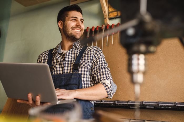 Man Holding Laptop — Frontier Connect in Newtown, QLD