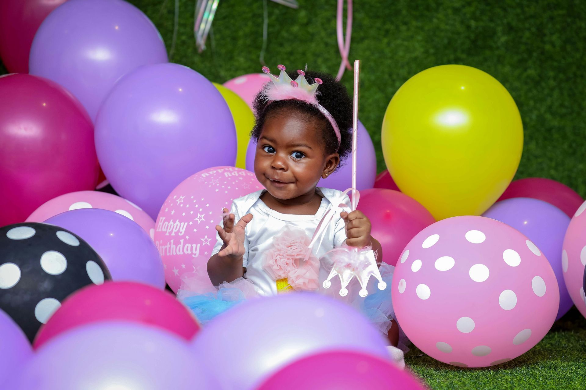 Image of a little girl surrounded by balloons