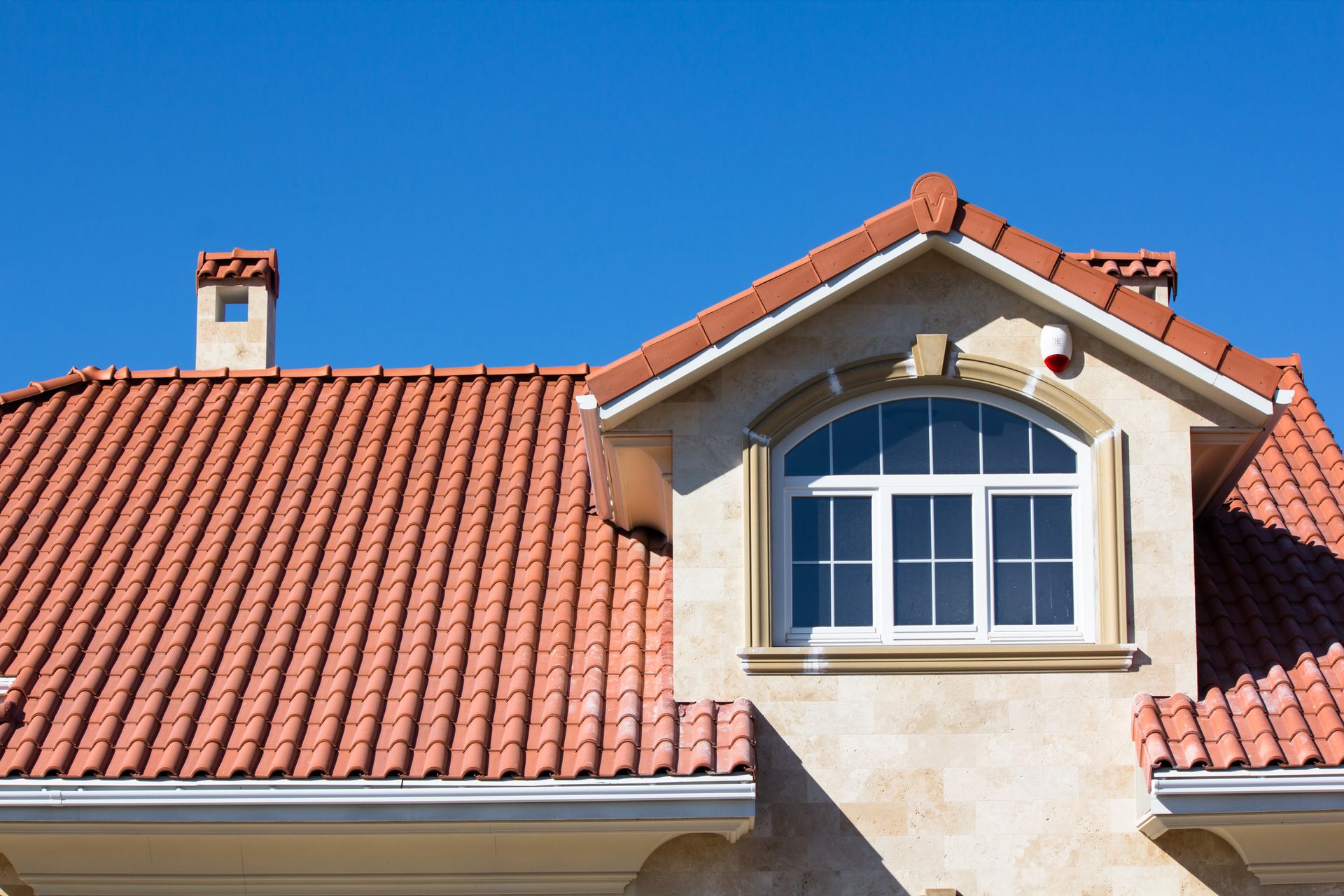 A house with a red tiled roof and a window