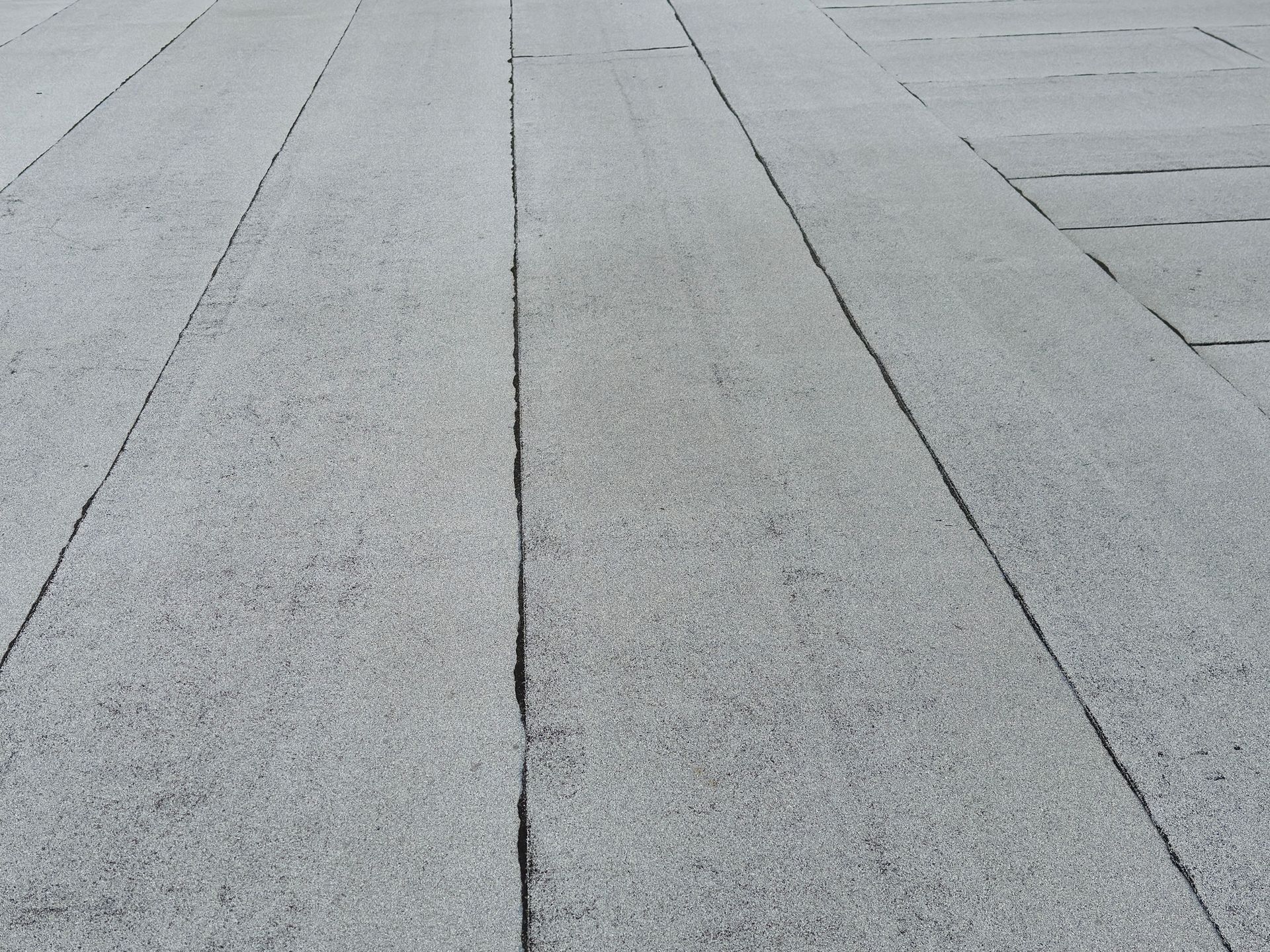 A close up of a gray concrete floor with a few lines on it.