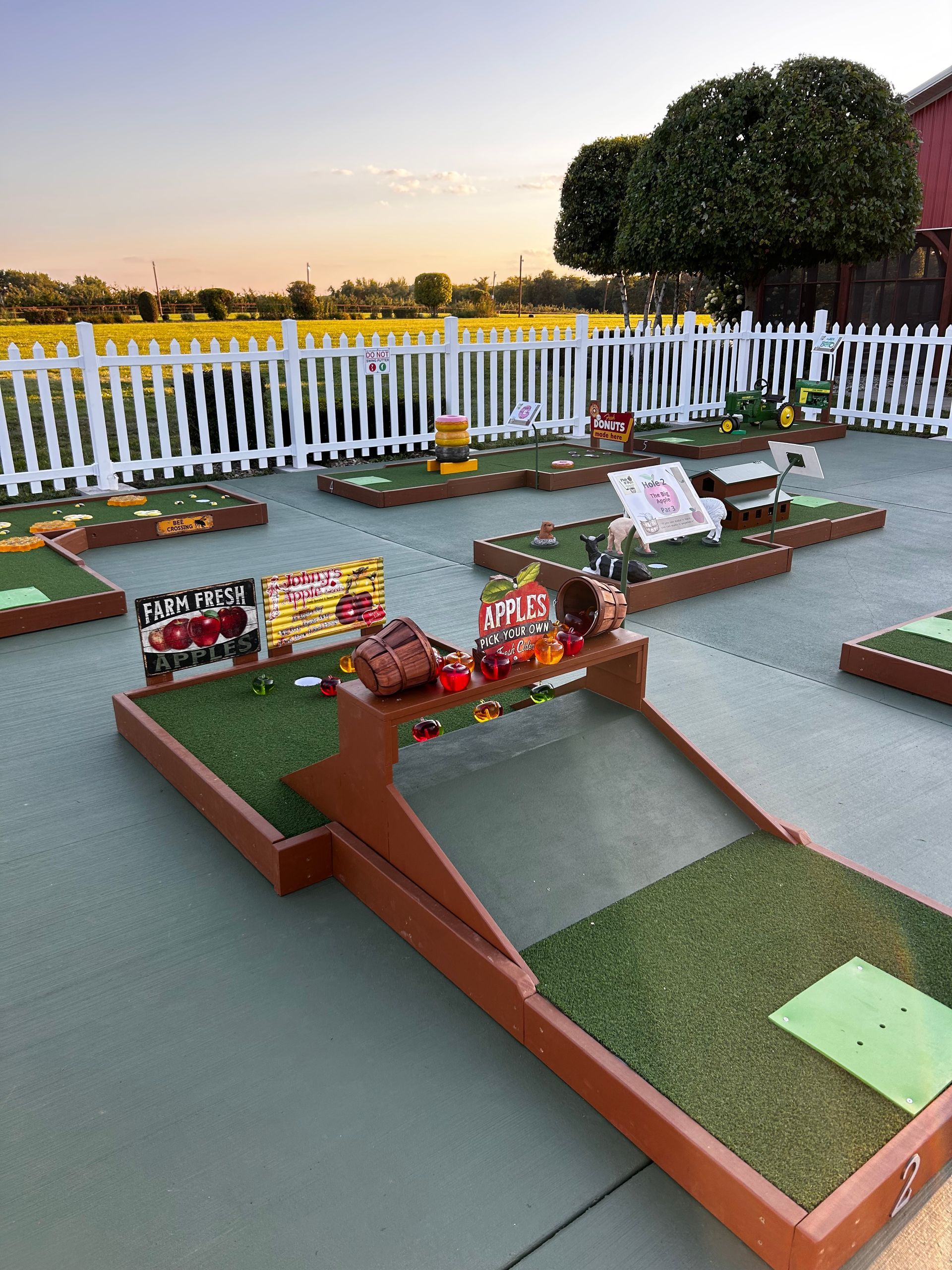 A colorful train is going down a path in a park