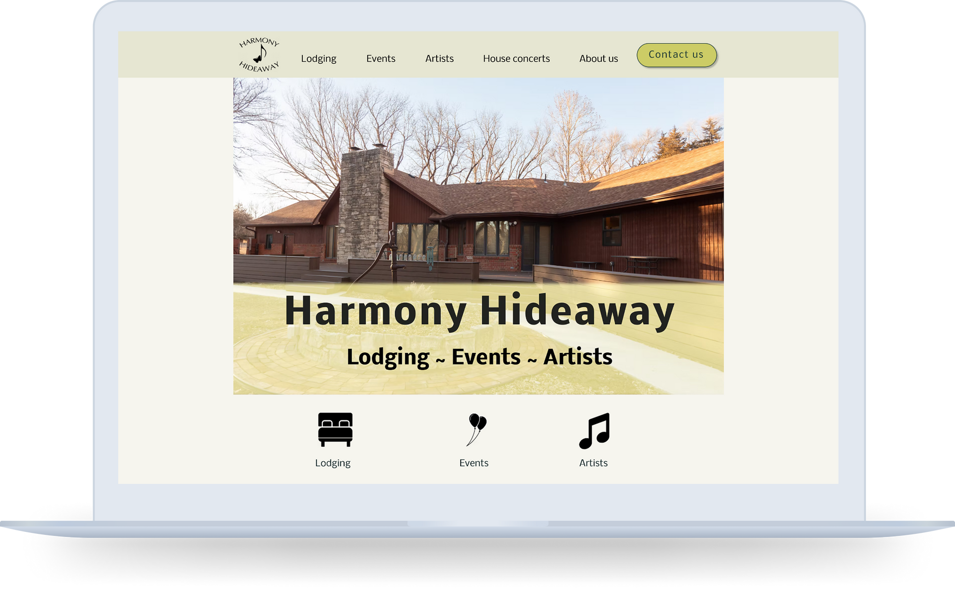 Laptop displaying the Harmony Hideaway website with a photo of a lodge.