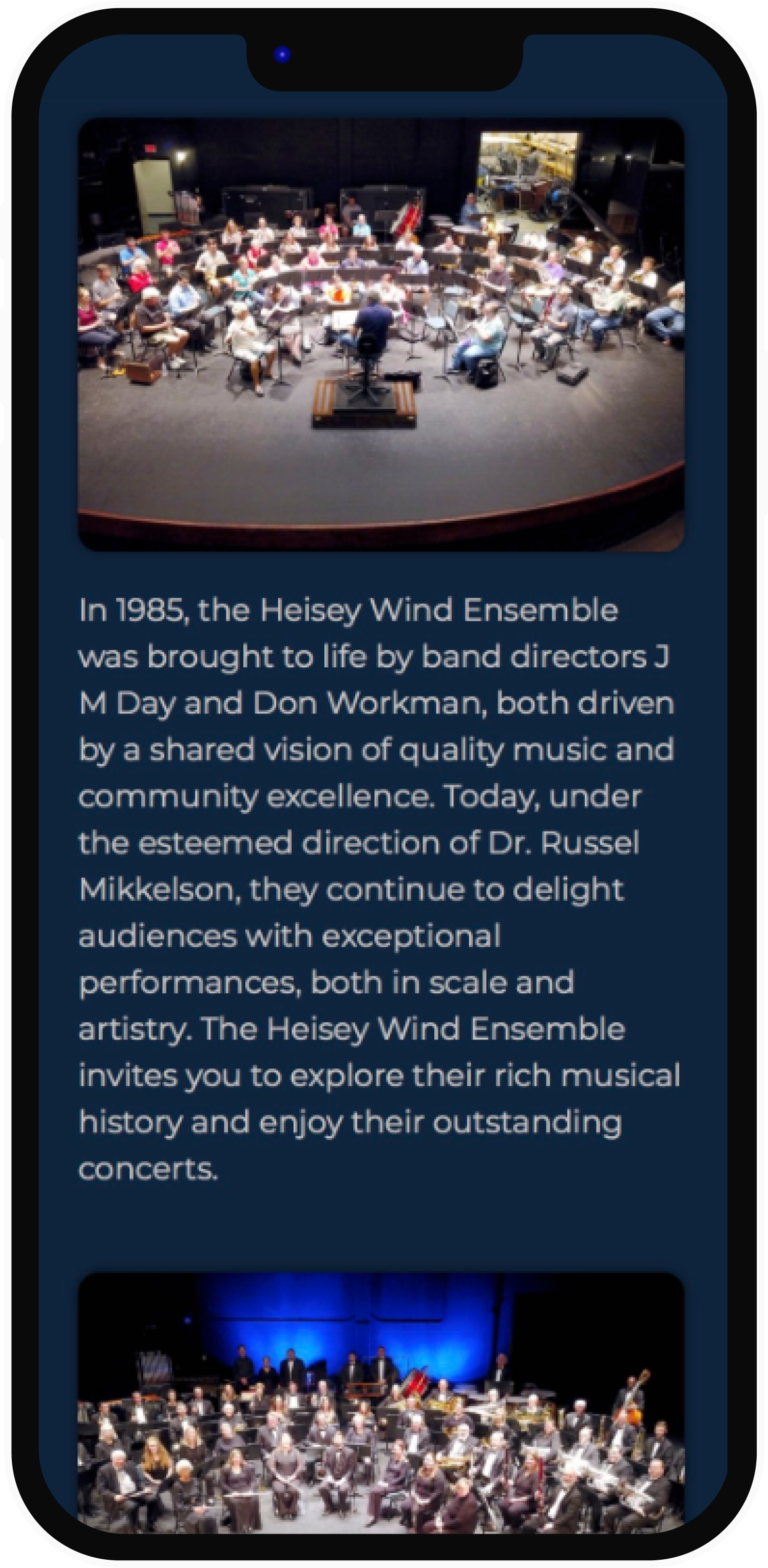 A smartphone displays text and two photos of a wind ensemble. The text describes the group's history and performances.