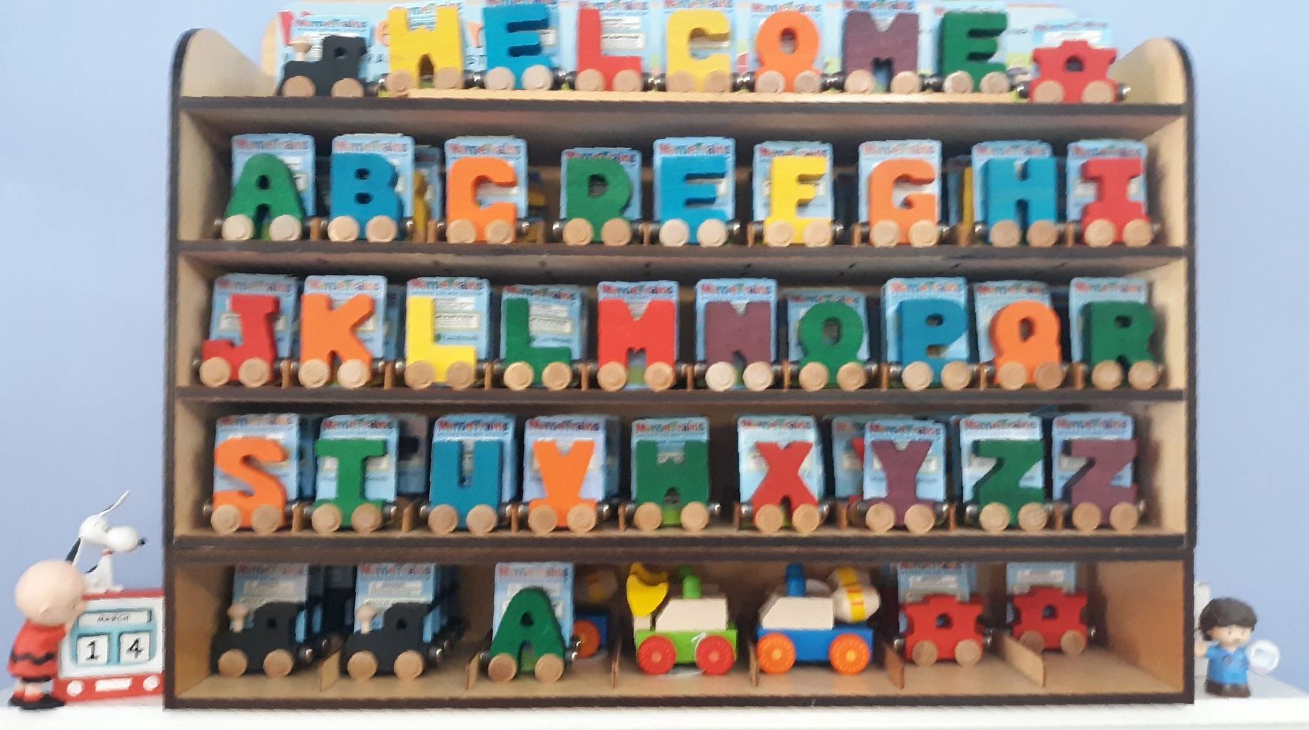 A wooden shelf with the alphabet on it