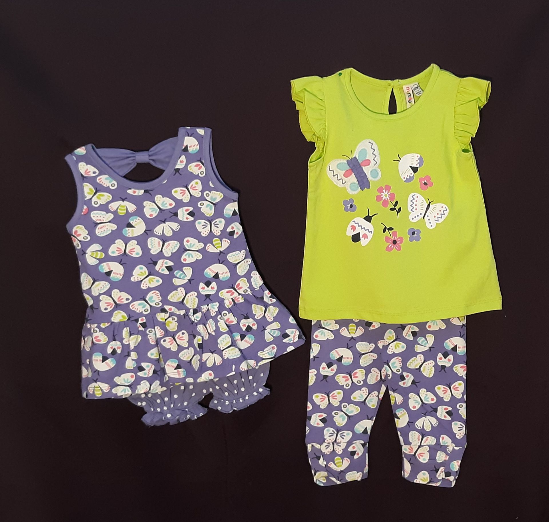 A purple dress and a green shirt with butterflies on them