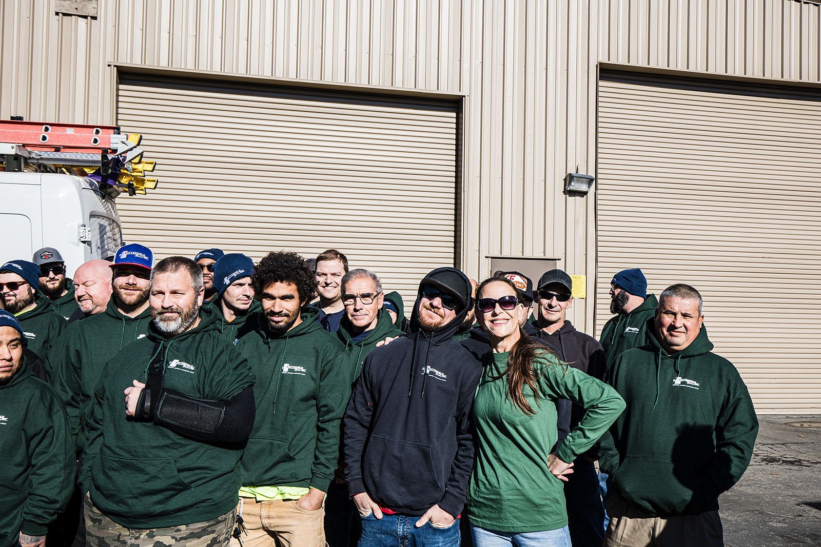a group of men are posing for a picture in a warehouse .