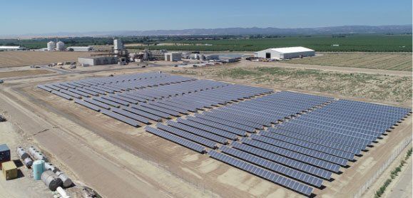 An aerial view of a large field of solar panels.