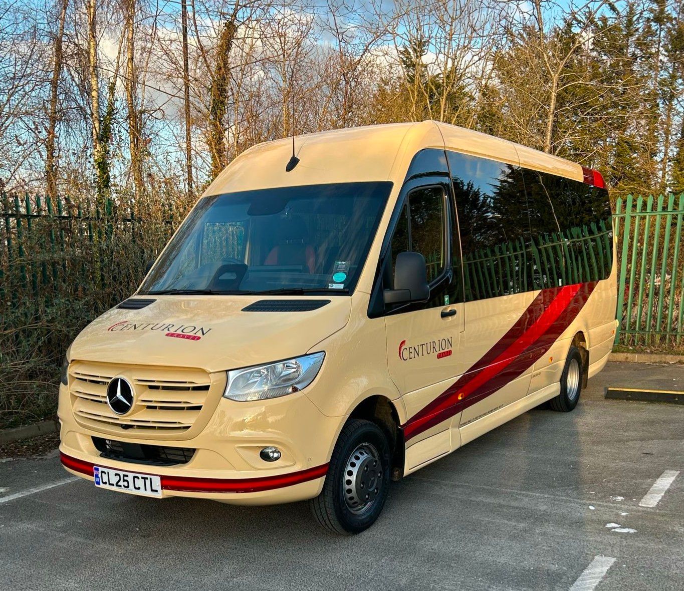 A mercedes sprinter van is parked in a parking lot.