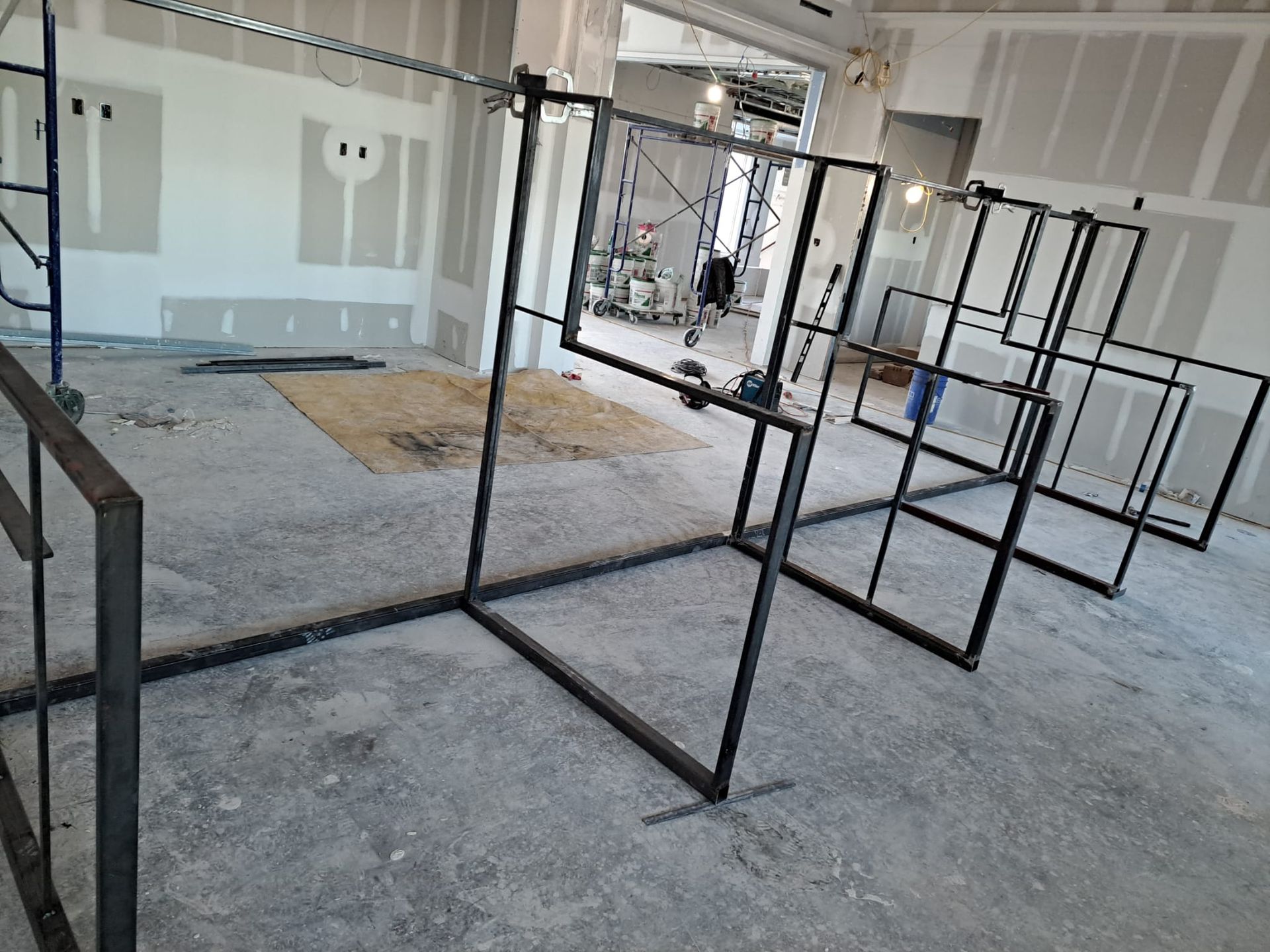 A room with a lot of metal frames on the floor.