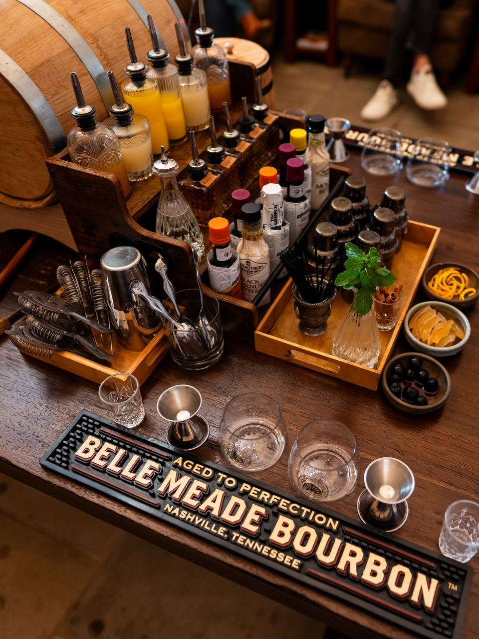 Two Belle Meade bourbon bottles on a wooden surface; one is labeled