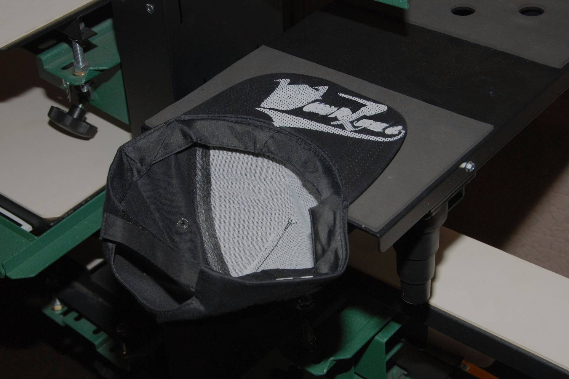 A black hat is sitting on top of a table