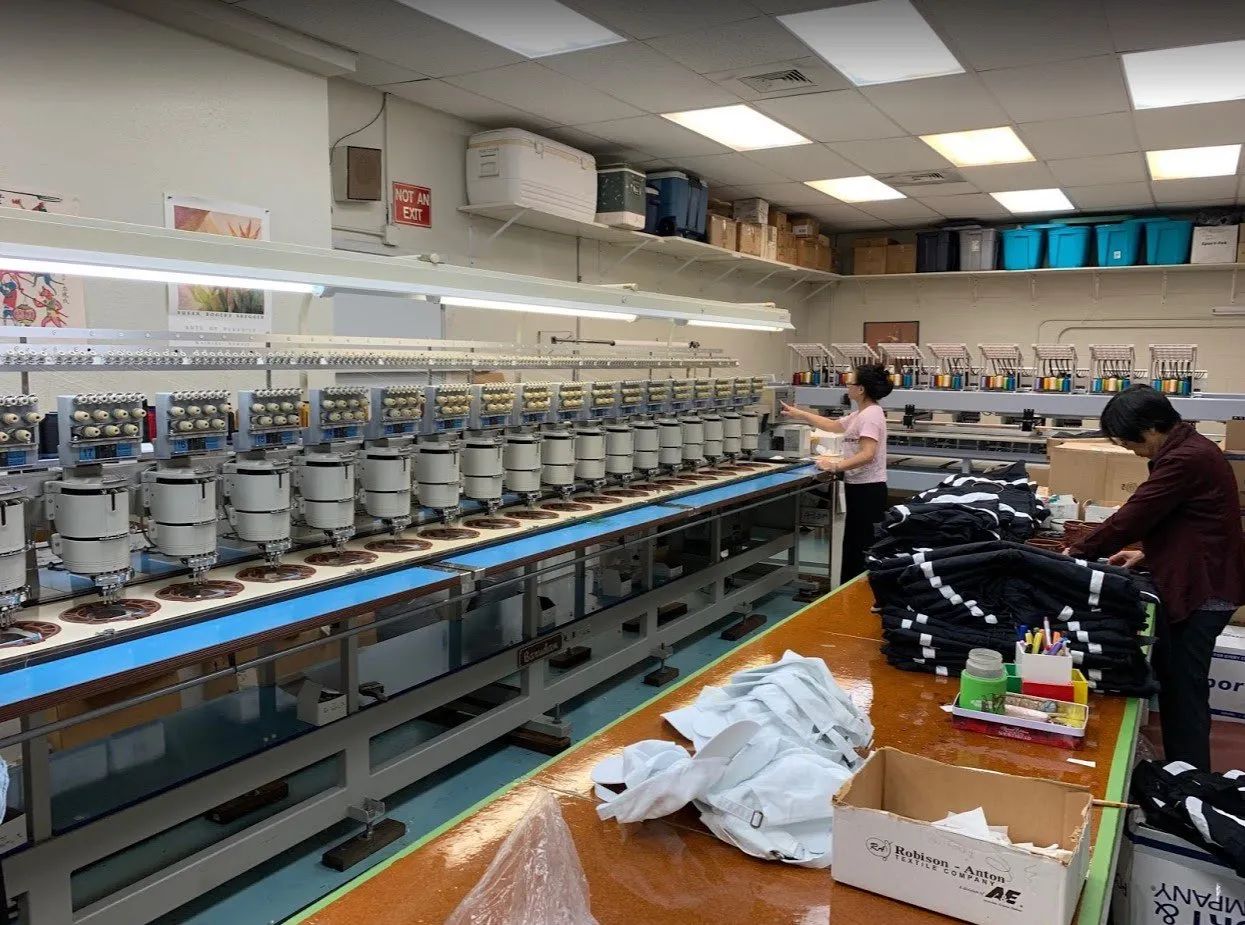 A woman is working on a machine in a factory.