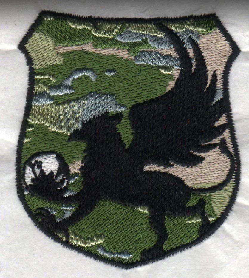 A shield with a silhouette of a griffin on it