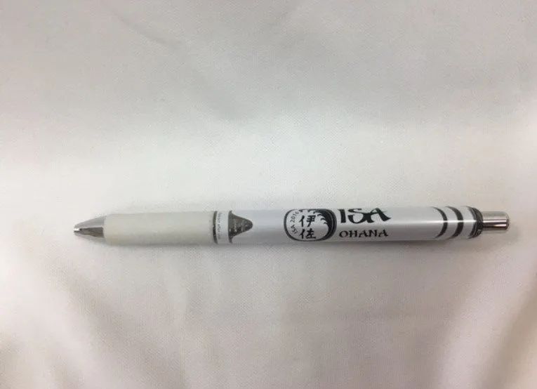A white pen is sitting on a white surface.