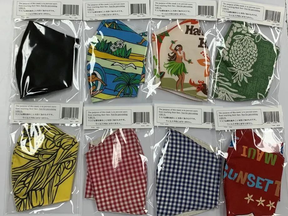 A bunch of face masks with one that says sunset on it