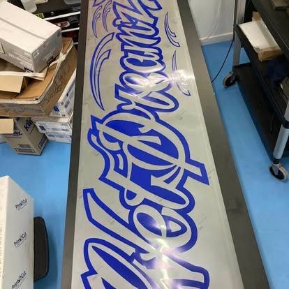 A blue and white sign with the word aloha on it — Cairns Custom T-Shirts In Cairns City, QLD