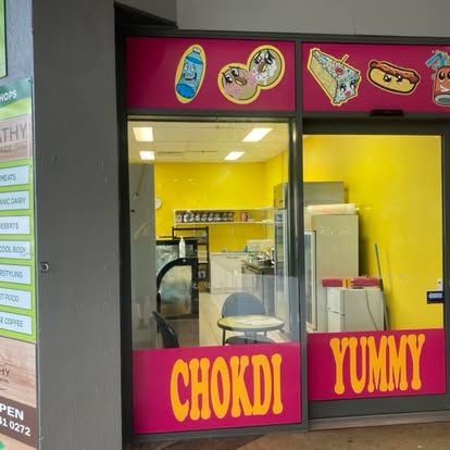 A store front with a sign that says chokdi yummy — Cairns Custom T-Shirts In Cairns City, QLD