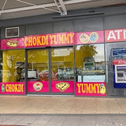 A store front with a sign that says chokdi yummy — Cairns Custom T-Shirts In Cairns City, QLD