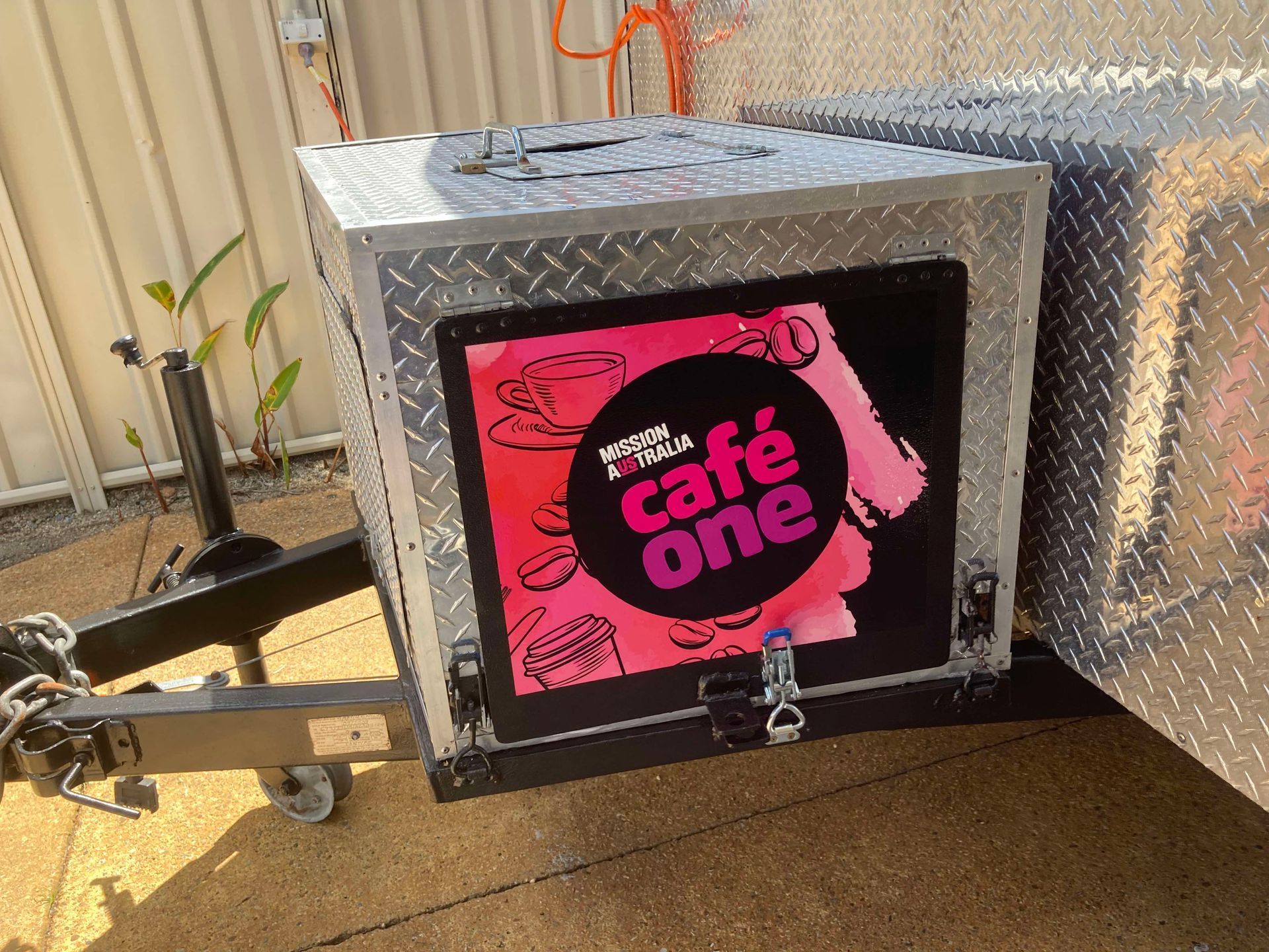 A trailer with a sign that says cafe one on it — Cairns Custom T-Shirts In Cairns City, QLD