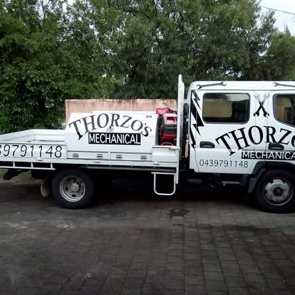 A white mechanical truck is parked on a brick driveway — Cairns Custom T-Shirts In Cairns City, QLD