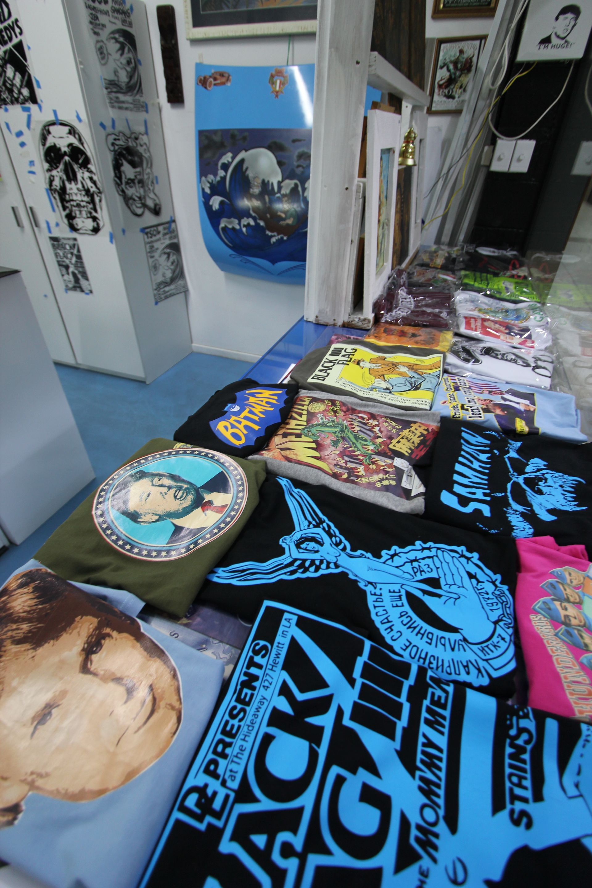 A Table With Lots Of Printed Shirts On It - Cairns Custom T-Shirts In Cairns City, QLD