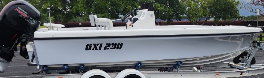 A white boat with a mercury engine is on a trailer — Cairns Custom T-Shirts In Cairns City, QLD