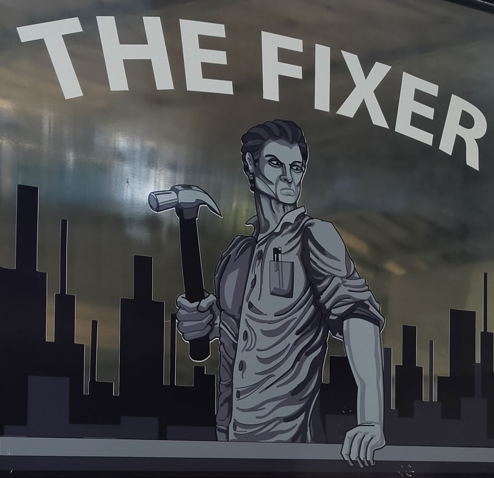 A black and white drawing of a man holding a hammer that says the fixer — Cairns Custom T-Shirts In Cairns City, QLD