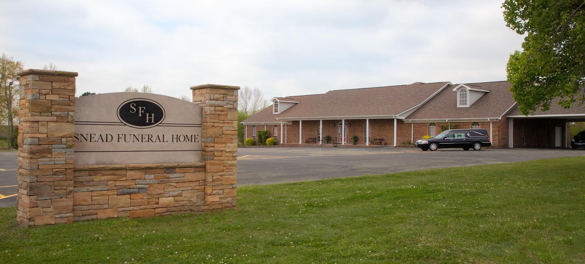 A large white building with a brown roof and a lot of windows.