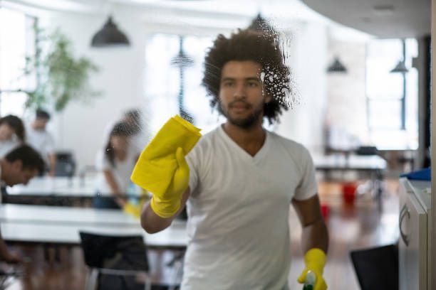 Man Cleaning A Glass Window - Holmen, WI - Green Glo Clean