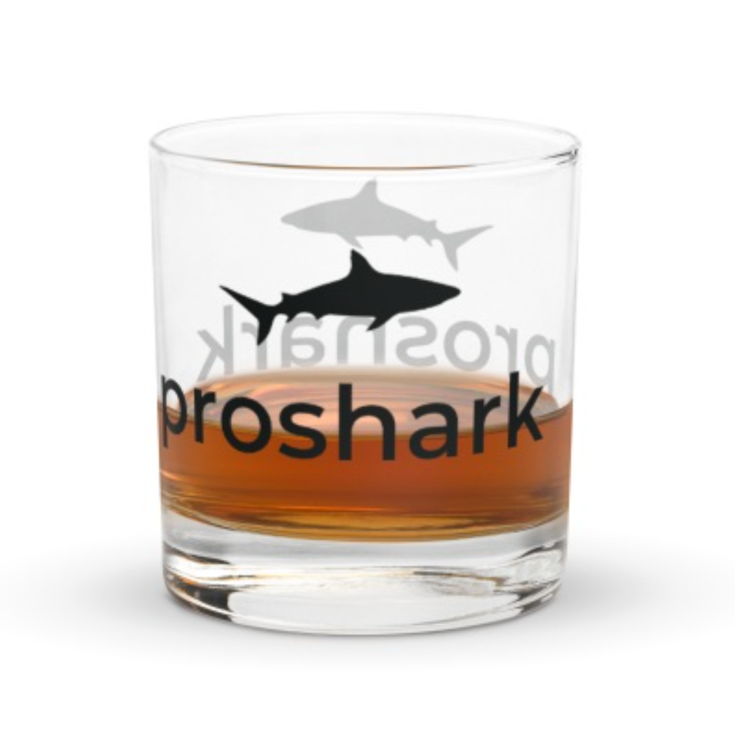 A whiskey glass that says proshark on it