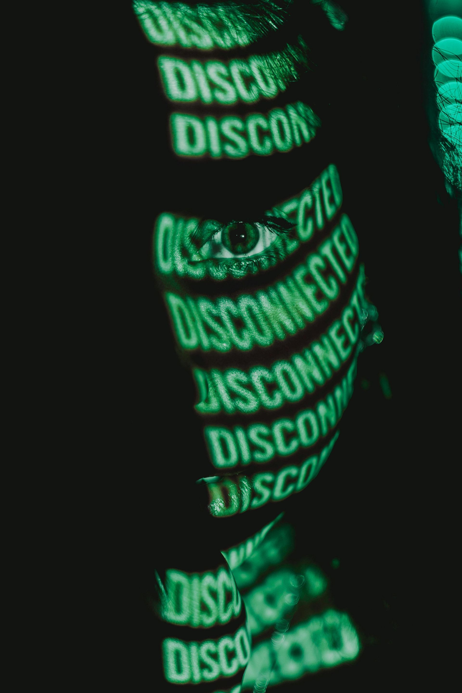 A person is wearing a black shirt with green writing on it.