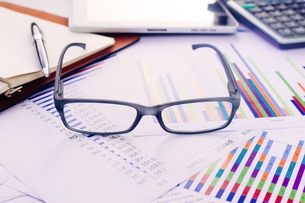 A Pair of Glasses is Sitting on Top of a Pile of Papers — Darwin BAS n Books In Adelaide River, NT