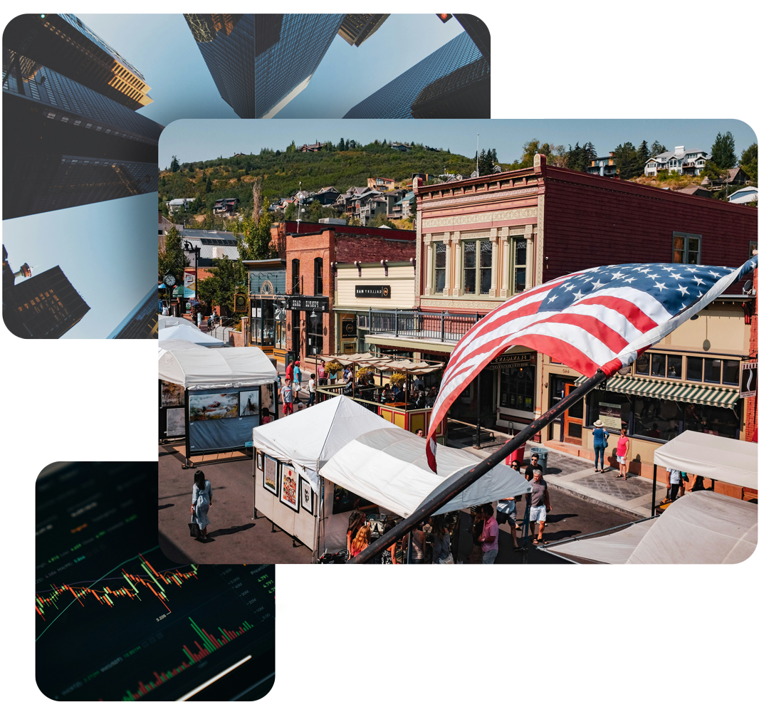 Downtown street scene with an American flag, market stalls, and buildings.